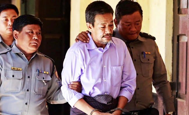 Kyi Lin (C), one of four men accused of being involved in the murder Ko Ni, Aung San Suu Kyi's advisor and friend, is escorted as he arrived at the court in Yangon on Friday. (AFP)