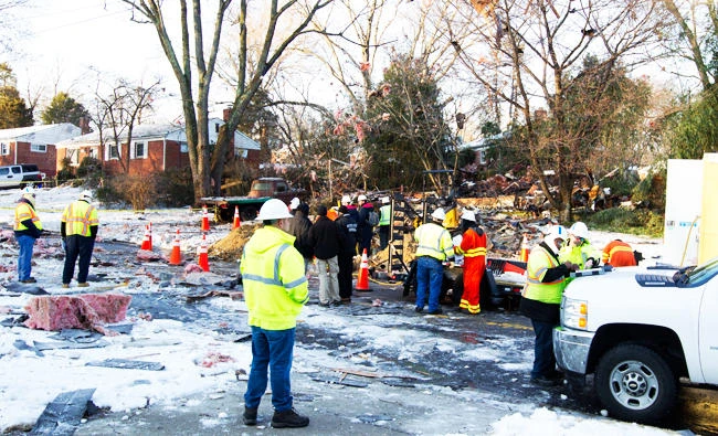 Gas company crew assist police after an explosion in Rockville, Md., on Friday. (AP)