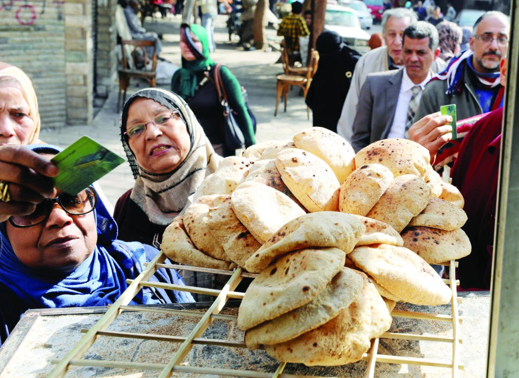 People buy bread at a bakery in Cairo. (Reuters)