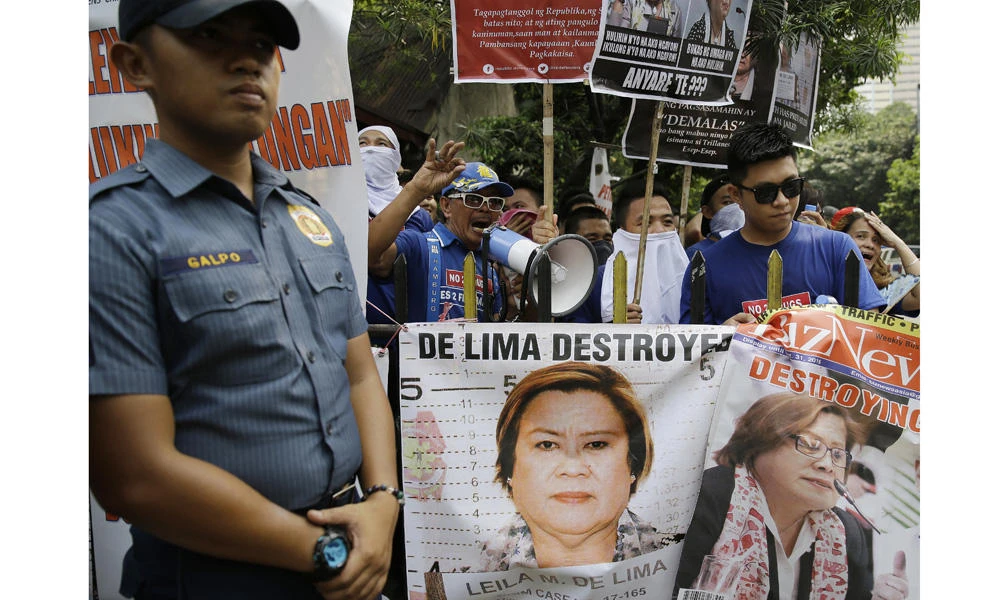 Protesters against detained Philippine Sen. Leila de Lima shout slogans during a rally outside the Supreme Court in Manila on March 14, 2017. De Lima, a leading critic of President Rodrigo Duterte's deadly crackdown on illegal drugs, petitioned the Supreme Court to nullify a Philippine court's arrest warrant against her for drug charges and order her release from detention at a police camp. (AP Photo/Aaron Favila)