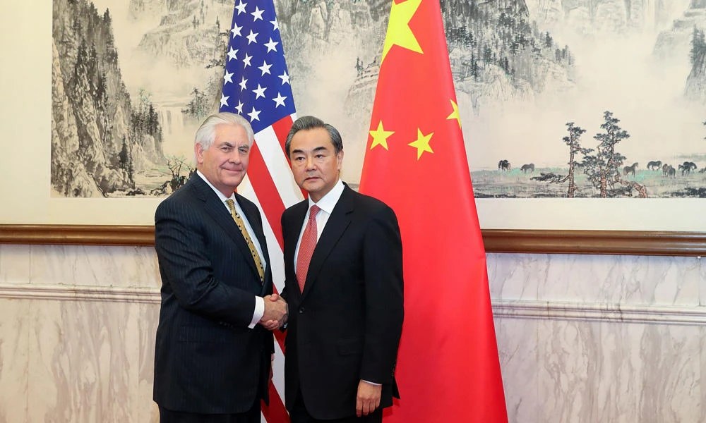China’s Foreign Minister Wang Yi (R) shakes hands with US Secretary of State Rex Tillerson at the Diaoyutai State Guesthouse in Beijing on Saturday. (AFP / POOL)