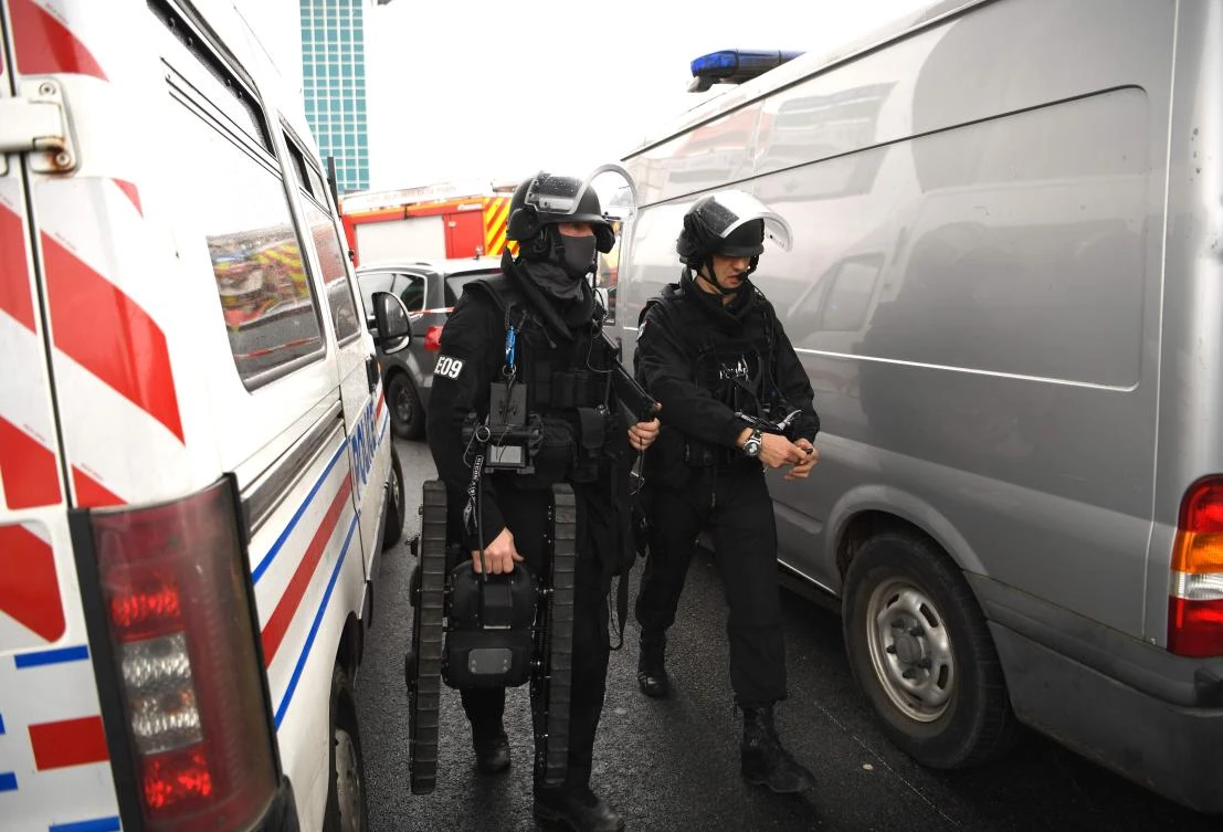 A French Police officer from the Raid unit carries a bomb disposal robot at Paris' Orly airport on Saturday following the shooting of a man by French security forces. (AFP / CHRISTOPHE SIMON)