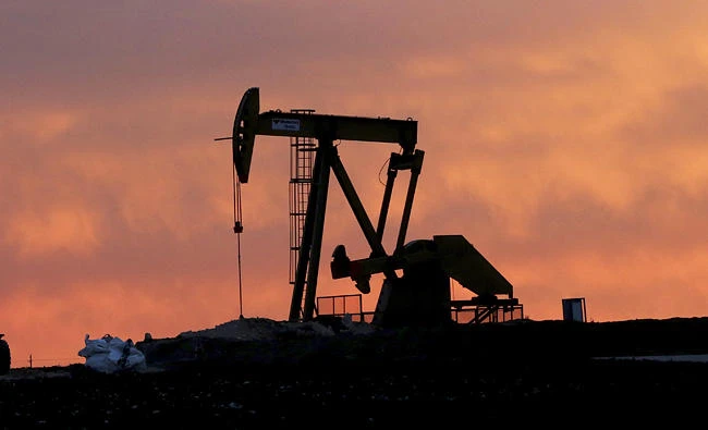 In this file photo taken on Dec. 22, 2014, a well pump works at sunset on a farm near Sweetwater, Texas. (AP)