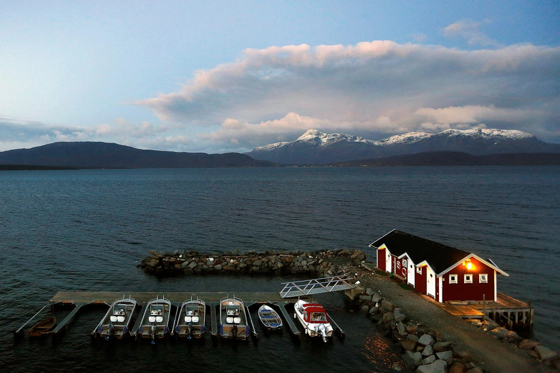 A small harbour and snow-capped mountains in Bals-Fiord in northern Norway. A new report shows Norway is the happiest country on Earth. (Reuters)