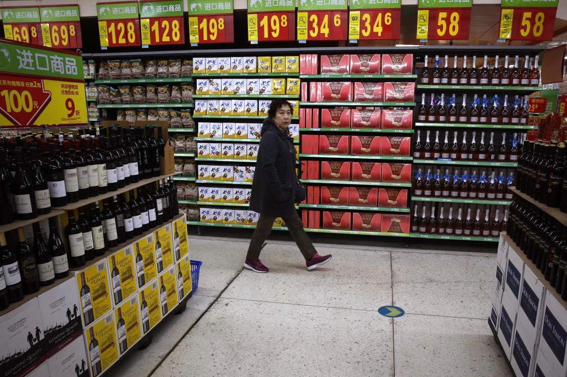 A woman walks by a section selling imported foods and beverages at Walmart in Beijing. (AP)