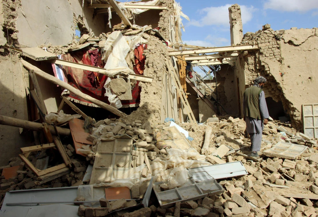 An Afghan man inspects a house destroyed during an air strike. (Reuters)