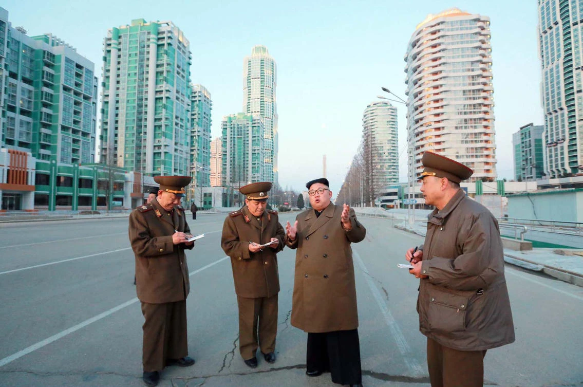 North Korean leader Kim Jong-Un (C) visiting construction sites of Ryomyong street in Pyongyang. (AFP PHOTO/KCNA VIA KNS)