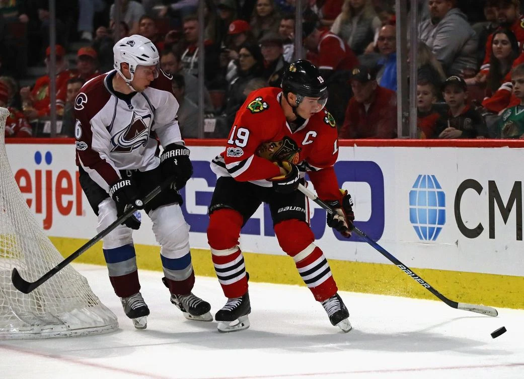 Jonathan Toews (19) of the Chicago Blackhawks tries to control the puck under presure from Erik Johnson (6) of the Colorado Avalanche at the United Center in Chicago, Illinois, on Sunday night. (AFP)