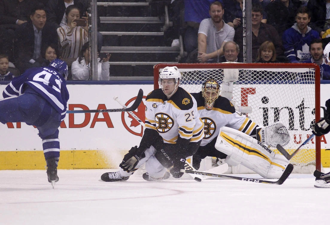 Toronto Maple Leafs forward Tyler Bozak (42) scores against Boston Bruins goaltendender Tuukka Rask (40) as defenseman Brandon Carlo (25) tries to block the shot at the Air Canada Centre on Monday night. (USA TODAY Sports)