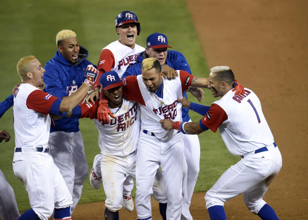 Puerto Rico third baseman Carlos Correa (1) and right fielder Eddie Rosario (17) celebrate the 4-3 extra innings victory against the Netherlands at Dodger Stadium, on Monday. (USA TODAY Sports)