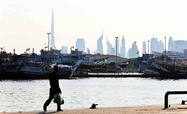 A man walks at Dubai creek in Dubai, United Arab Emirates, in this November 24, 2013 file photo. (REUTERS)