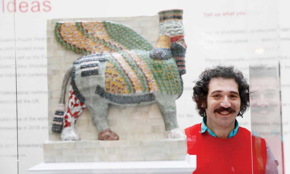 Michael Rakowitz beside a model of his sculpture. (Reuters)