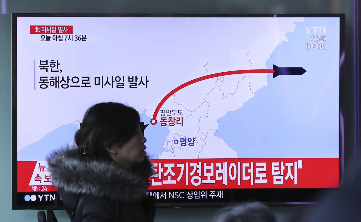FILE - In this March 6, 2017 file photo, a visitor walks by the TV screen showing a news program reporting about North Korea's missile firing, at Seoul Train Station in Seoul, South Korea. The U.S. military expects another North Korean missile launch in the next several days, American defense officials said Tuesday, March 21, 2017. (AP Photo/Lee Jin-man, File)