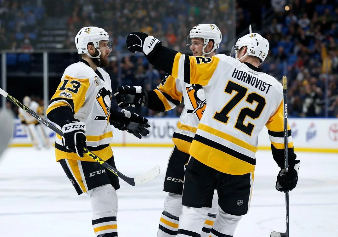 Nick Bonino (13) of the Pittsburgh Penguins celebrates his goal against the Buffalo Sabres with Tom Kuhnhackl (34) and Patric Hornqvist (72) during the third period at the KeyBank Center in Buffalo, New York, on Tuesday night. (AFP)