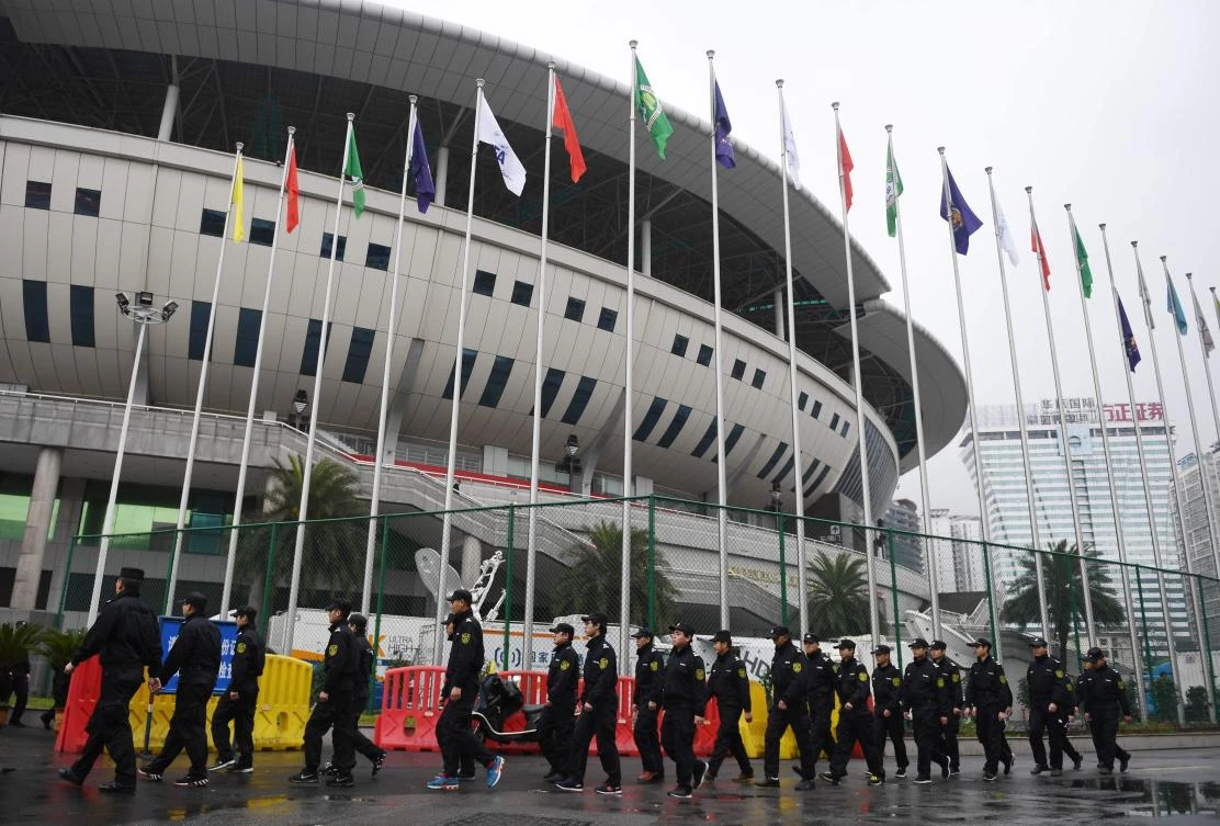 Security guards march outside the Helong stadium, the venue for a World Cup football qualifying match between China and South Korea, in Changsha. (AFP)