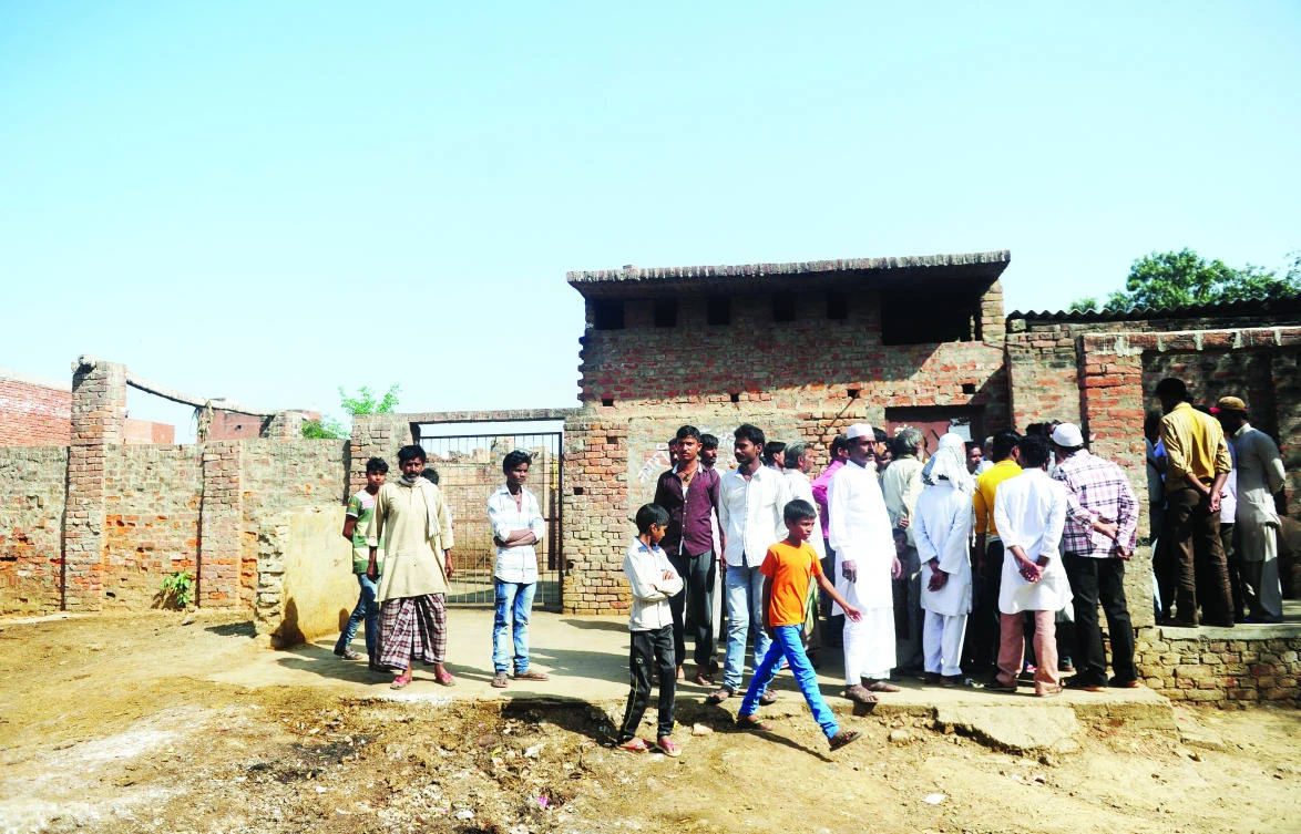 Indian Muslim butchers and traders gather outside a closed slaughter house in Allahabad on Tuesday. (AFP)