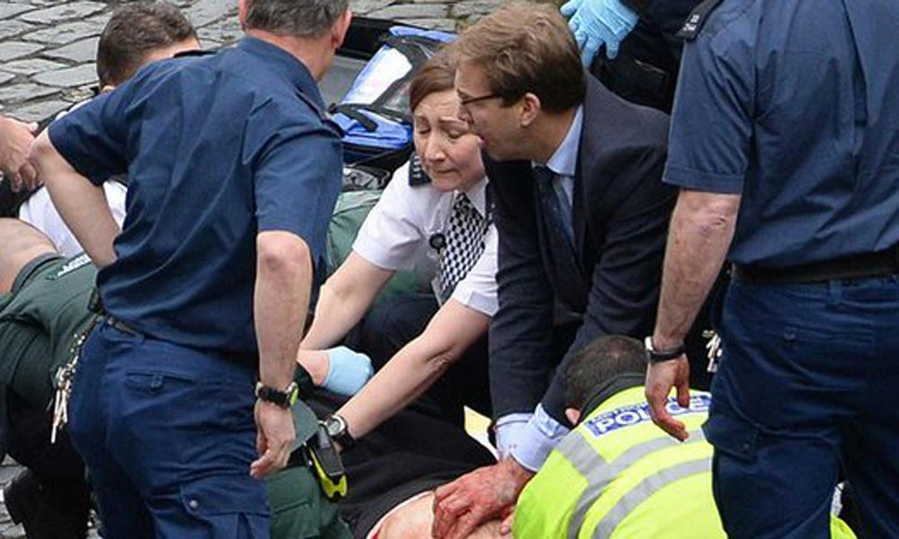 In this picture shared on social media, British MP Tobias Ellwood gives CPR to a police officer wounded in the terror attack. (Social Media)