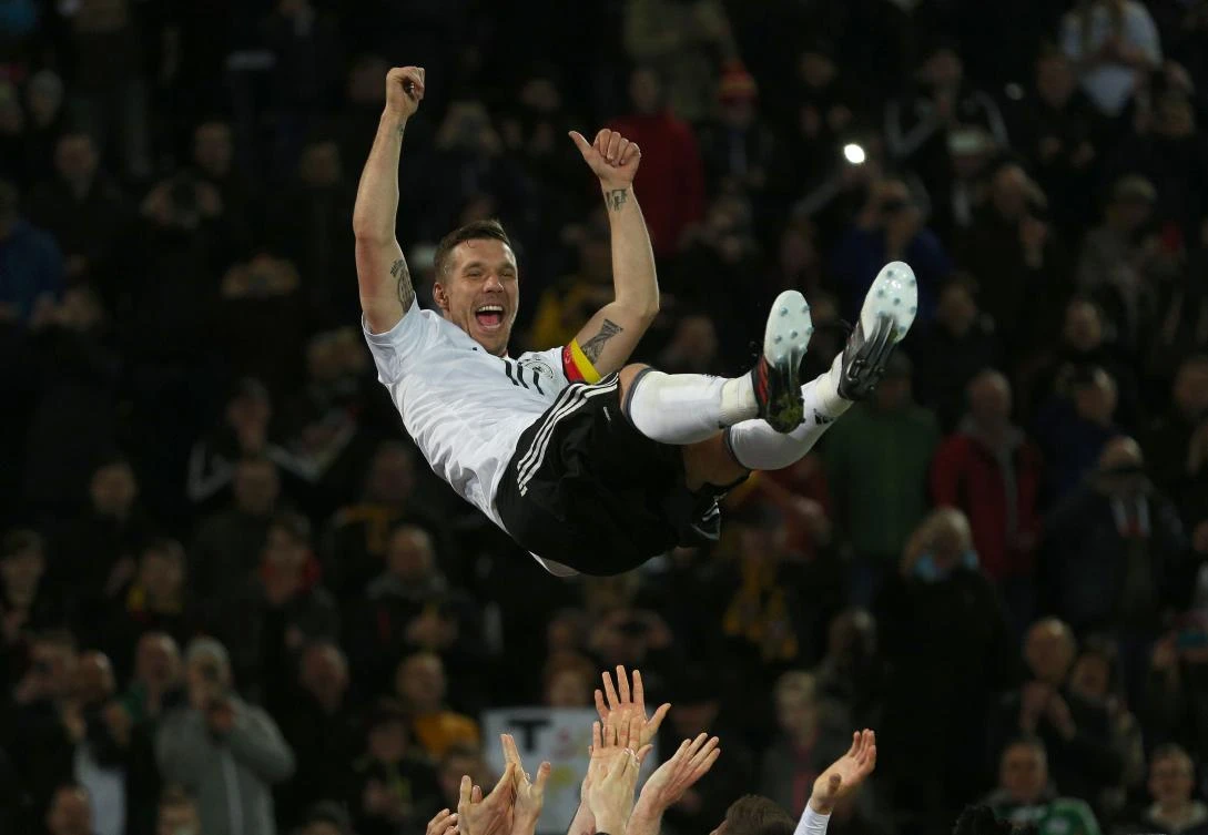 Teammates throw Germany's Lukas Podolski in the air after the friendly football match against England in Dortmund on Wednesday night. (AFP)