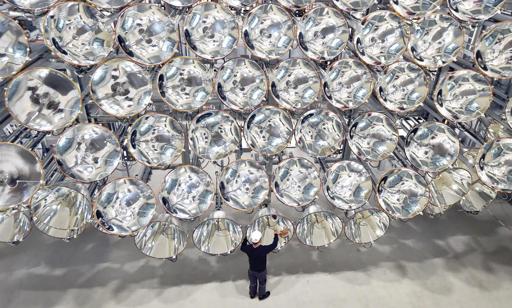 German engineer Volkmar Dohmen stands in front of xenon short-arc lamps in the DLR German national aeronautics and space research center in Juelich, western Germany. The lights are part of an artificial sun that will be used for research purposes. (AP)