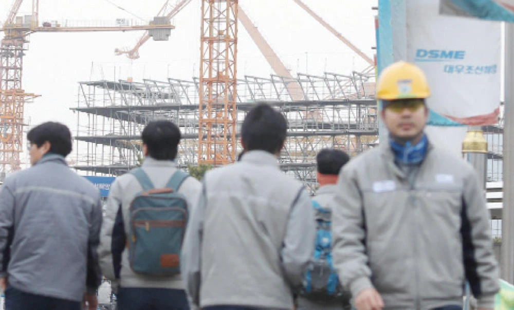 Employees of Daewoo Shipbuilding & Marine Engineering walk in a shipyard in Geoje, South Korea, on Thursday. (Reuters)
