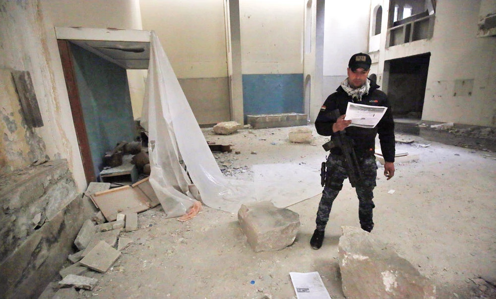 A member of the Iraqi forces inspects the damaged interior of the destroyed museum of Mosul after it was recaptured by Iraqi forces from Daesh. (AFP)