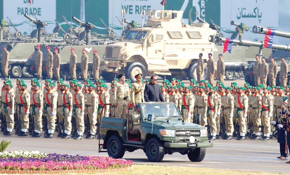 Pakistan’s President Mamnoon Hussain, center on a military vehicle, reviews a military parade to mark Pakistan’s Republic Day in Islamabad on Thursday. (AP)