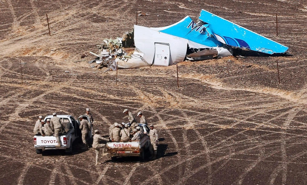In this Nov. 1, 2015 file photo provided by Russian Emergency Situations Ministry, Egyptian military approach a plane's tail at the wreckage of a passenger jet bound for St. Petersburg in Russia that crashed in Hassana, Egypt. The Egyptian army said Thursday that it lost 10 soldiers in fighting with Islamic extremists in central Sinai. (AP file)