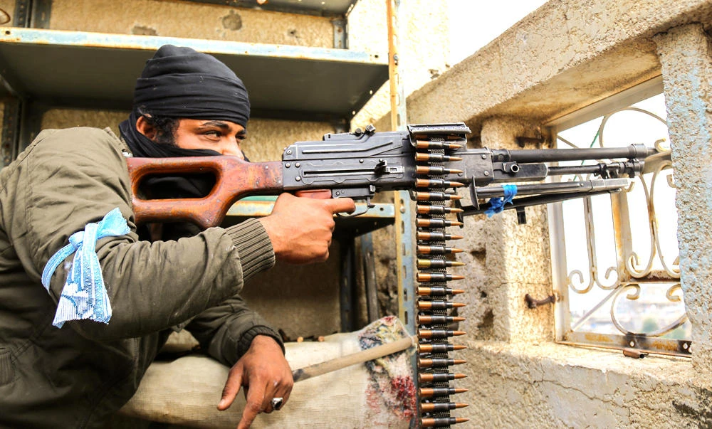 This file photo taken on December 15, 2015 shows a Yemeni tribesman from the Popular Resistance Committees, supporting forces loyal to President Abedrabbo Mansour Hadi, holding a position in the country's third city Taez. Yemen's war has killed around 7,700 people and wounded 42,500 others, according to UN figures. (AFP / AHMAD AL-BASHA)