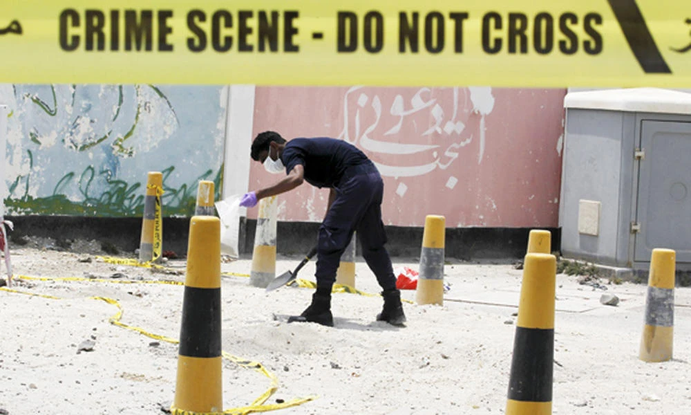 In this file photo, an explosives specialist police officer collects samples after a bomb blast in the village of Sitra, south of Manama, Bahrain, on July 28, 2015. A Bahraini court on Thursday sentenced three men to death after they were convicted on charges of terrorism and involvement in 2014 bomb attacks that injured a number of police officers. (REUTERS file photo)