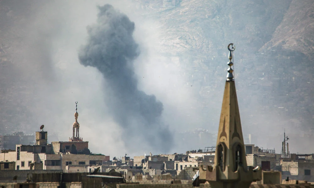 A general view shows moke rising from buildings following an air strike on Jobar, a rebel-held district on the eastern outskirts of the Syrian capital Damascus on Friday. (AFP / AMER ALMOHIBANY)