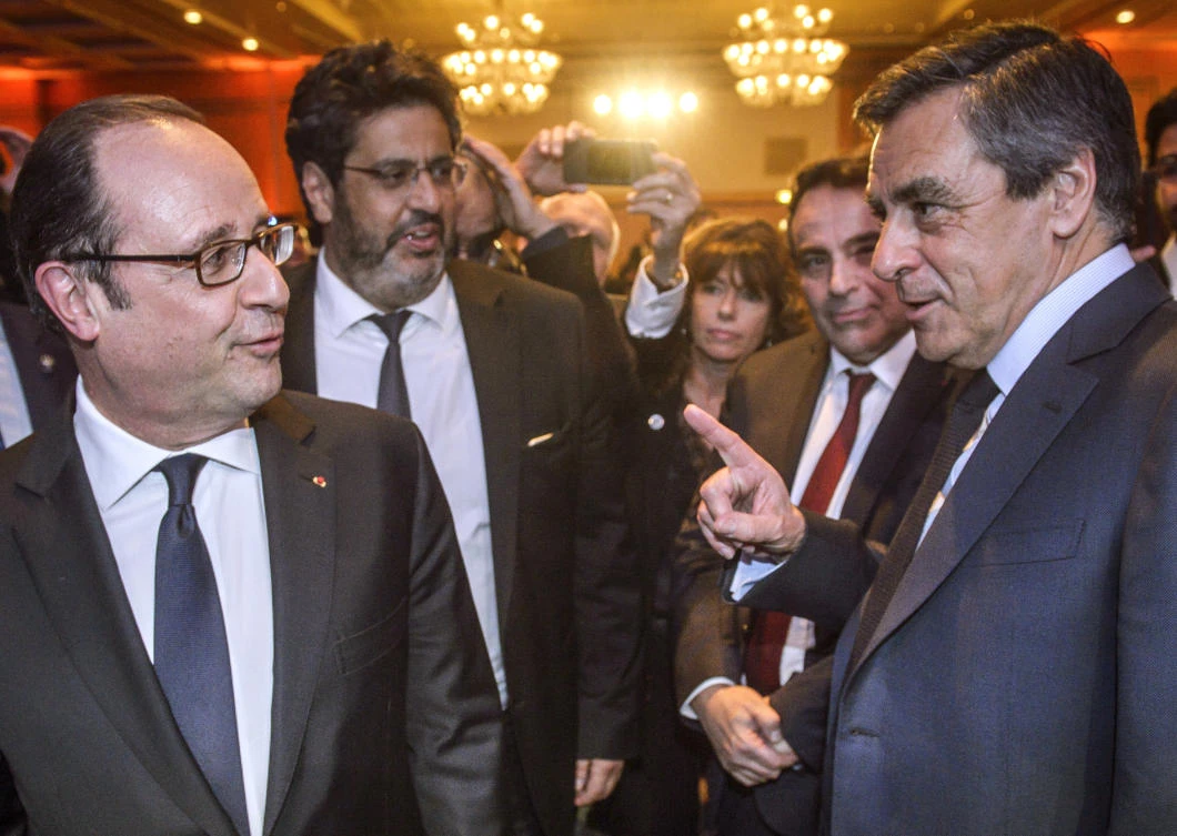 French President Francois Hollande, left, talks with Francois Fillon, the conservative candidate for the French presidential elections in Paris in this file photo. (AP)