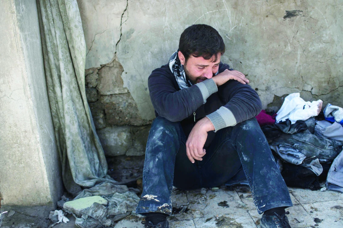 Ahmed Pesher cries next to the destroyed houses where he says 23 members of his family were killed during a fight between Iraqi forces and Daesh on the western side of Mosul, Iraq, Friday. (AP)