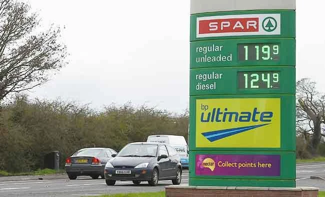 Traffic pass by a sign displaying prices for Unleaded Petrol and Diesel outside a garage in Chester in north west England, in this March 21, 2017 photo. (AFP)