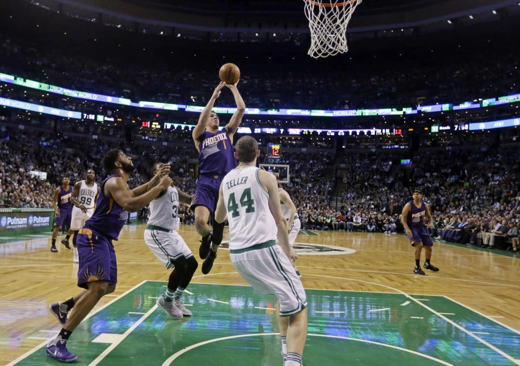 Phoenix Suns guard Devin Booker (1) goes up for a shot against the Boston Celtics in the first quarter of their NBA basketball game in Boston on Friday night. (AP)
