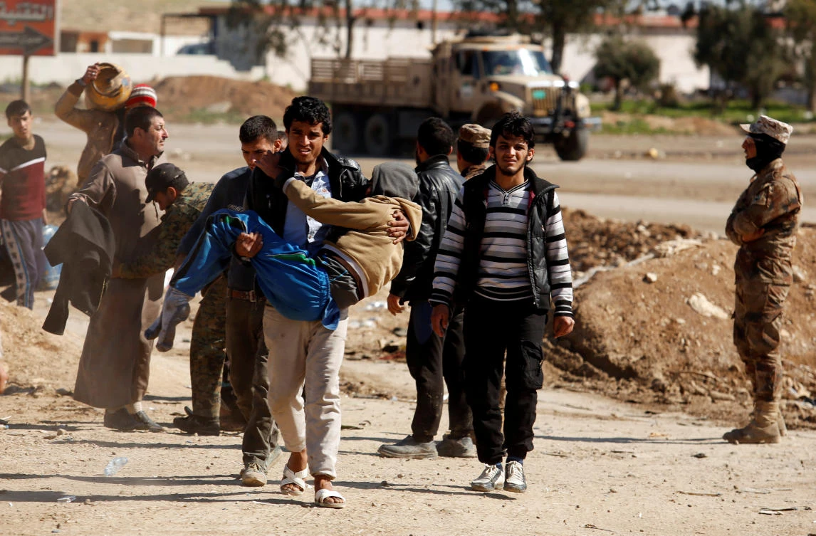 Displaced people are checked by Iraqi forces as Iraqi forces battle with Daesh militants, in western Mosul, Iraq. (Reuters)