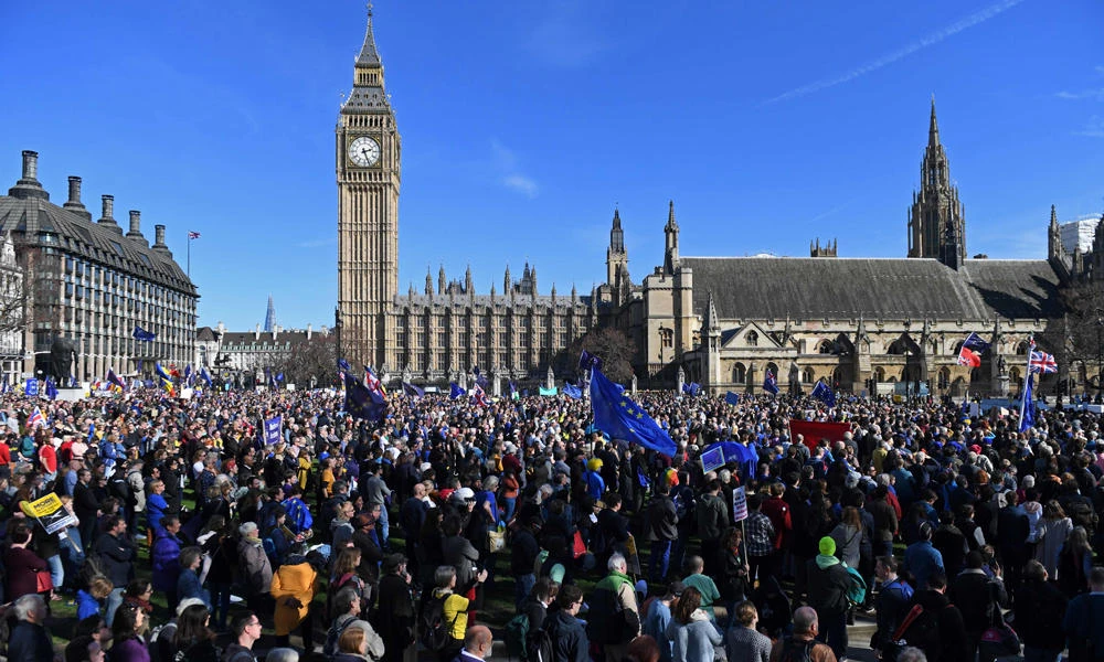 Demonstrators holding EU flags gather at a rally near the Houses of Parliament in Parliament Square following an anti Brexit, pro-European Union (EU) march in London onSaturday, ahead of the British government's planned triggering of Article 50 next week. (AFP / Chris J Ratcliffe)