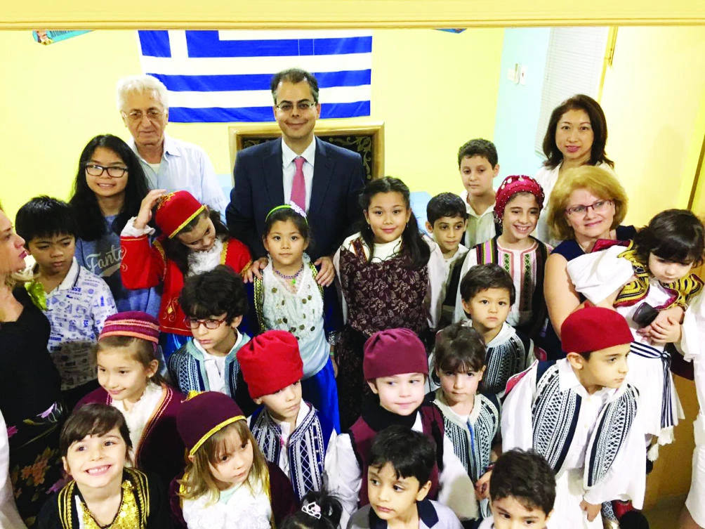 Evgenios Kalpyris, consul-general of Greece in Jeddah, with youngsters.