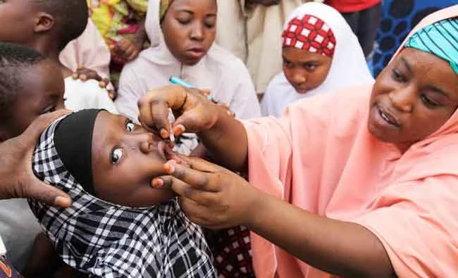 In this April 13, 2014 file photo, an unidentified health official administers a polio vaccine to a child in Kawo Kano, Nigeria. (AP)