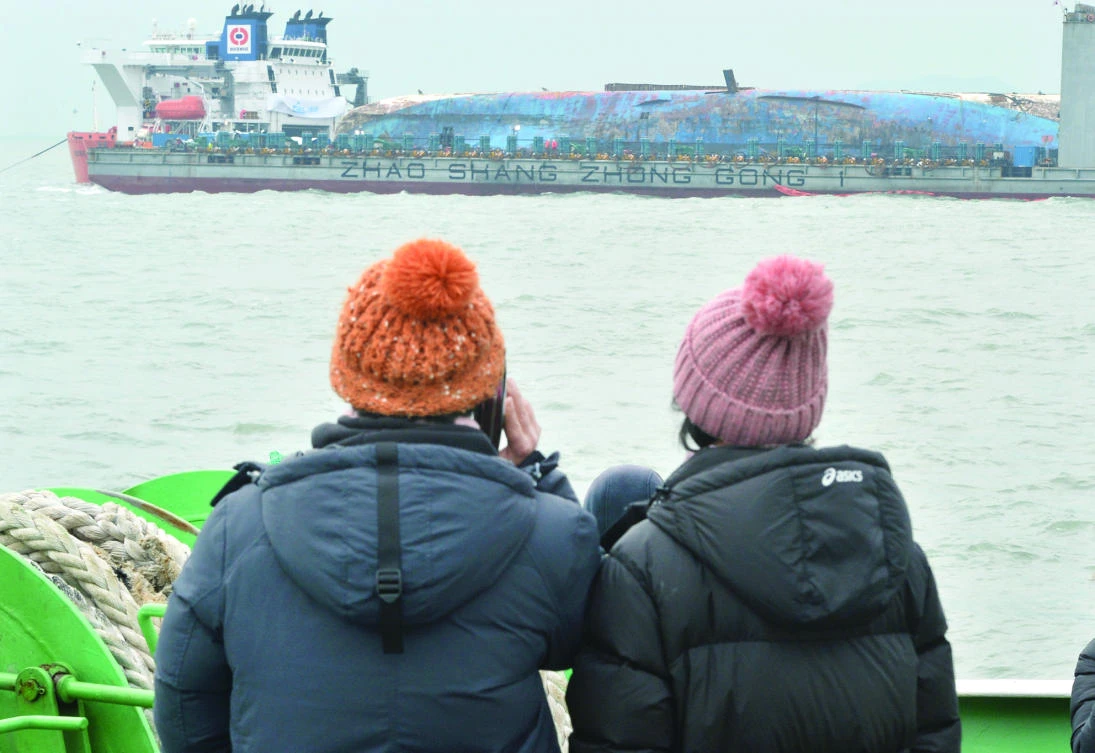 Family members of victims look at the Sewol ferry during its salvage operations at the sea off Jindo, South Korea, on Saturday. (Reuters)