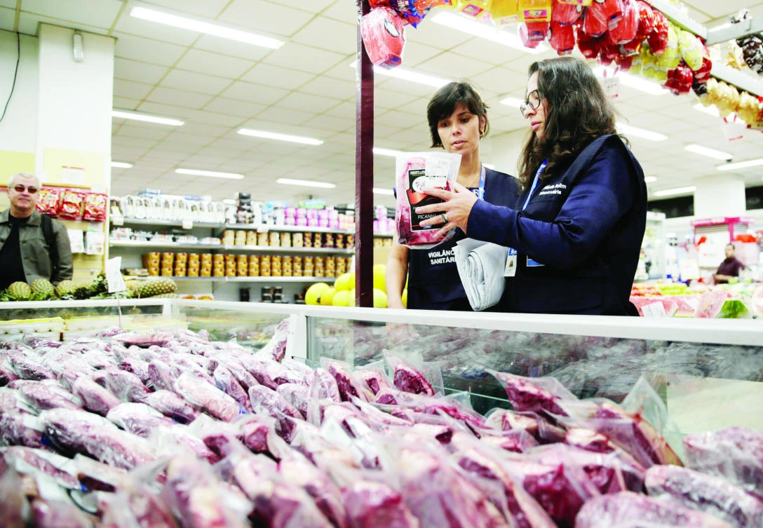 Members of the Public Health Surveillance Agency (PHSA) collect meats to analyse in their laboratory, at a supermarket in Rio de Janeiro, Brazil. (Reuters)