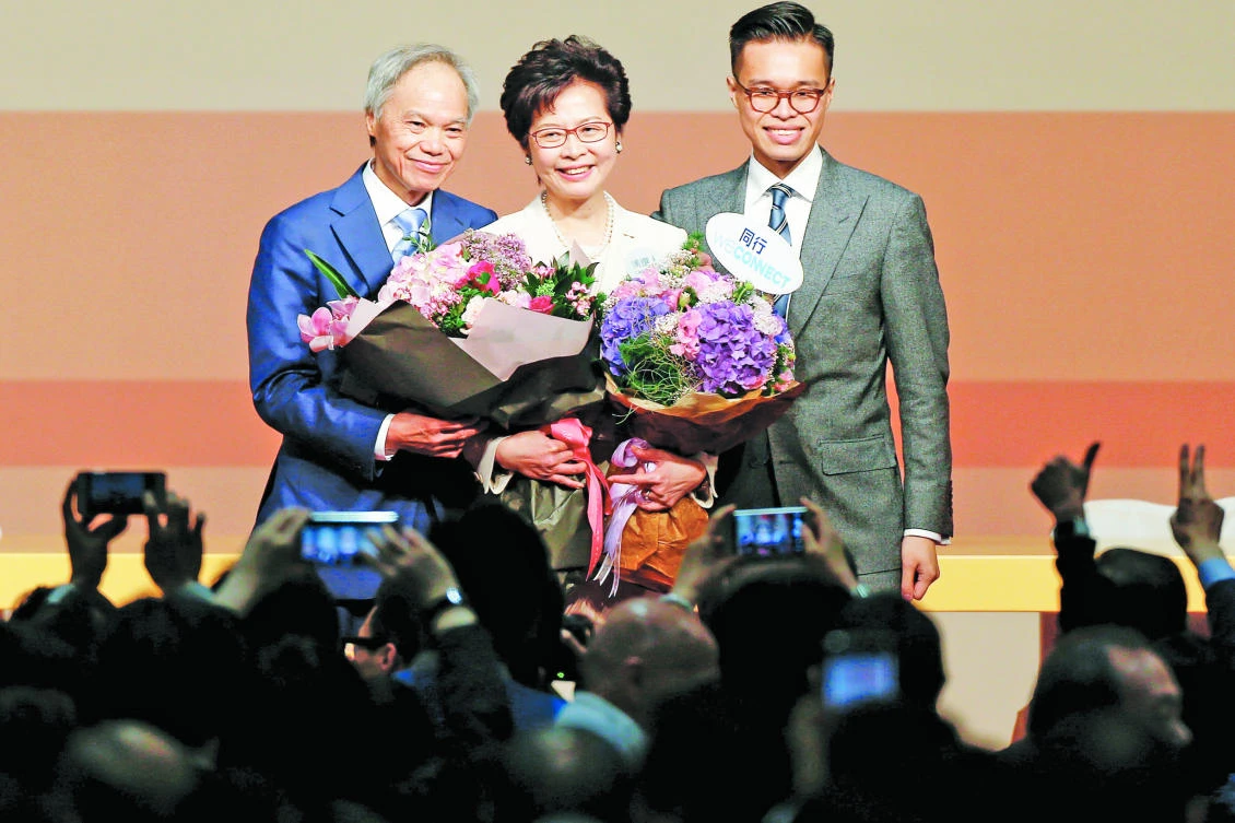 Carrie Lam is congratulated by her husband and son after she won the election for Hong Kong’s next chief executive on Sunday. (Reuters)