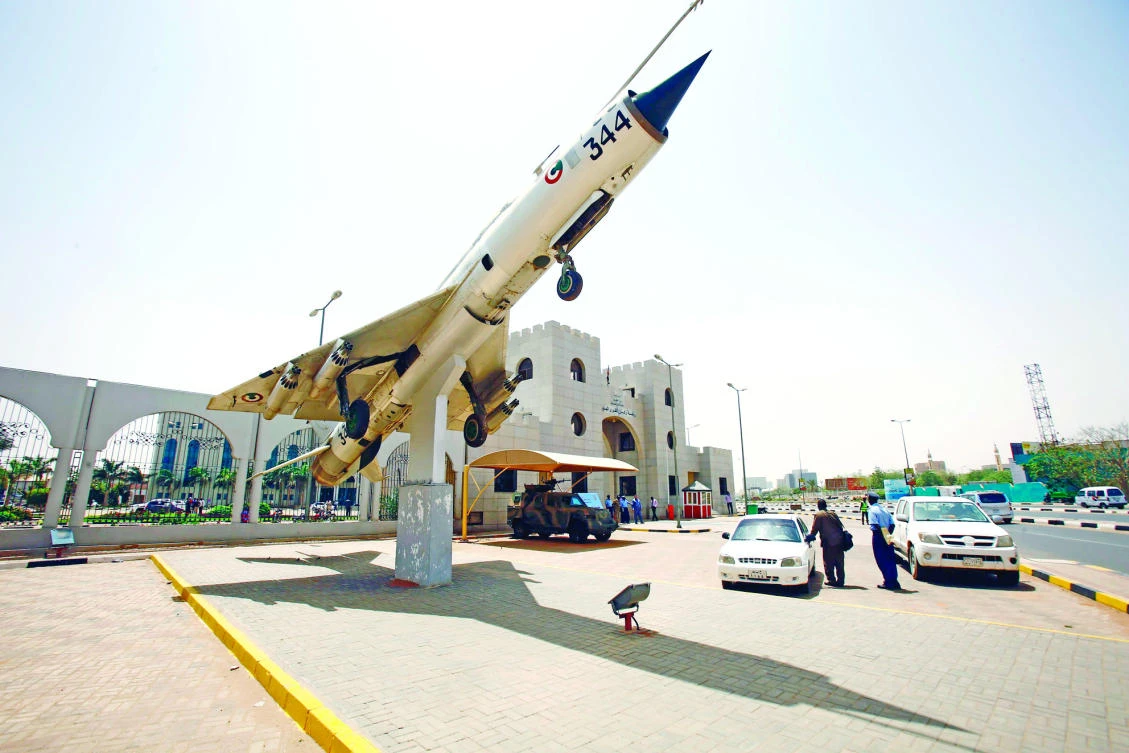 A MiG-21 is seen at the entrance of a conference center where acting chief of staff of Sudanese air force delivered a press conference in Khartoum on Sunday, ahead of joint air force drill with Saudi Arabia. (AFP)