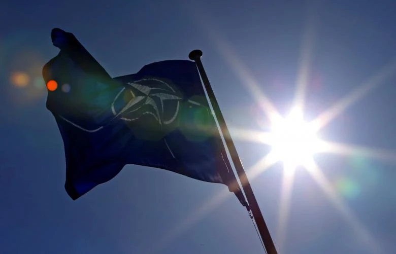 A NATO flag flies at the Alliance's headquarters in Brussels. (REUTERS)