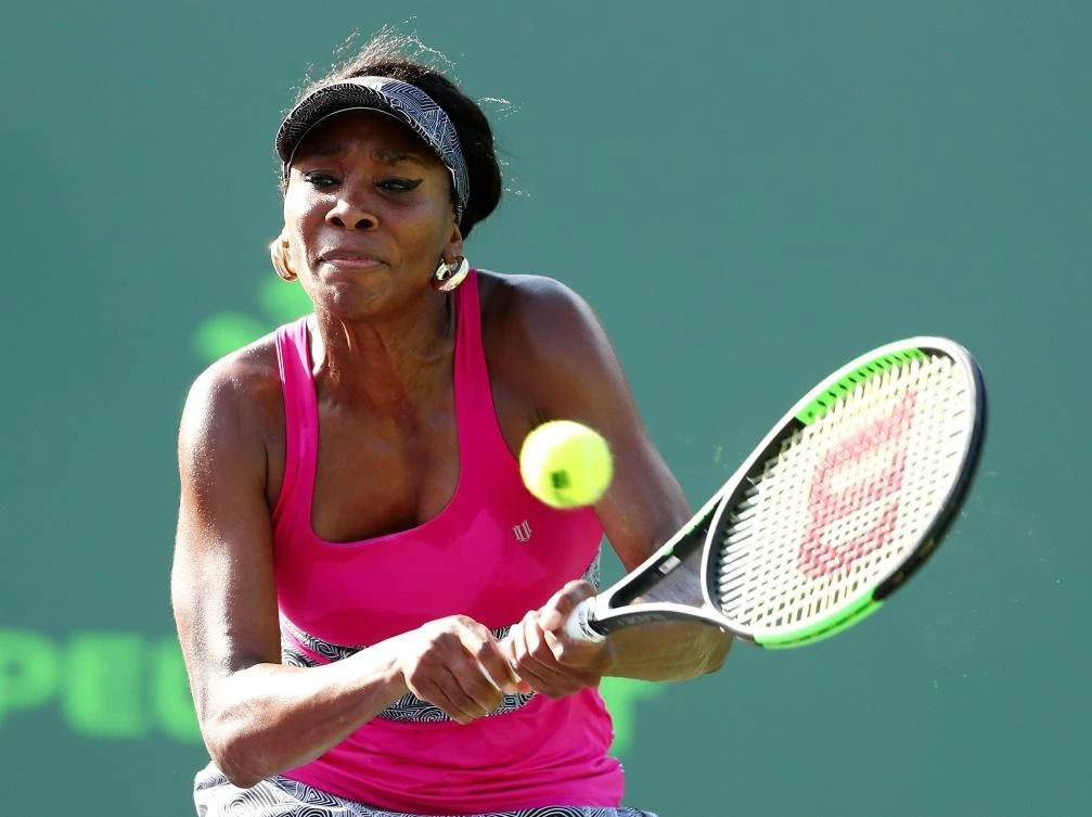 Venus Williams returns a shot against Patricia Maria Tig of Romania during Day 7 of the Miami Open at Crandon Park Tennis Center on Sunday in Key Biscayne, Florida. (AFP)