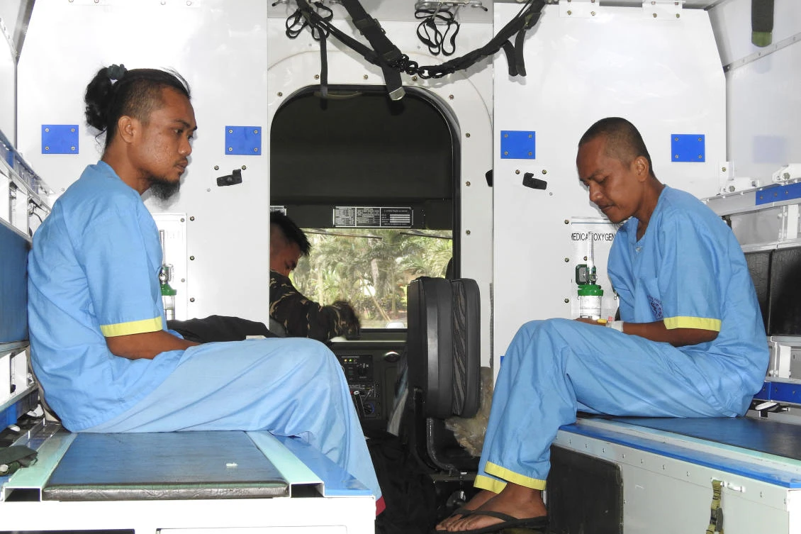 Malaysians are pictured inside a military ambulance after they were rescued. (Reuters)