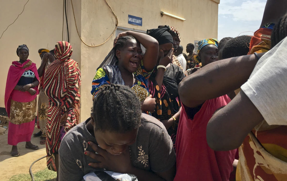 Relatives of the six aid workers who were ambushed and killed grieve as they wait to collect and bury the bodies. (AP Photo)