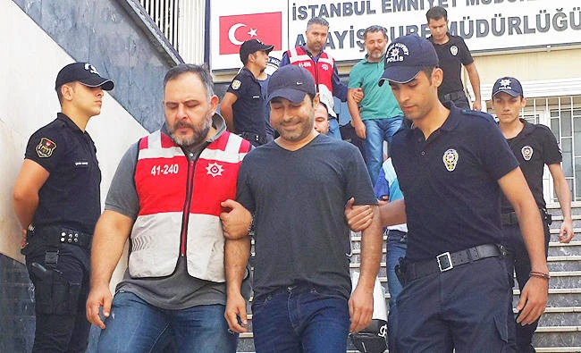 In this Sept. 3, 2016 file photo, Turkish police officers escort Turkish pop singer Atilla Tas, centre, to the police headquarters following his arrest, in Istanbul. (AP)