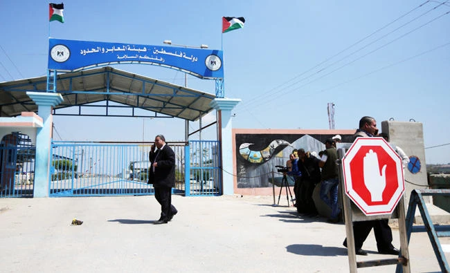 Palestinians wait at Erez border crossing into Israel, in Beit Hanun, in the northern Gaza Strip on Sunday, after it was shut by the Hamas after blaming the Jewish state for the assassination of one of its officials in the Palestinian enclave. (AFP)