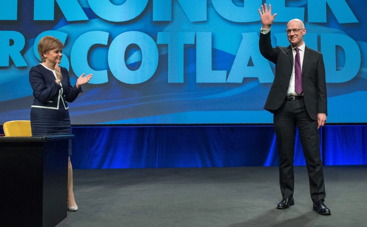 Scottish National Party (SNP) leader, and Scotland’s First Minister, Nicola Sturgeon (L) applauds SNP MSP John Swinney after he spoke during the Scottish National Party (SNP) Spring Conference in Aberdeen, east of Scotland, on March 17, 2017. (AFP)
