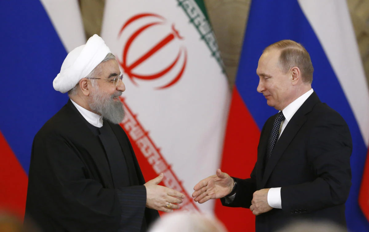 Russian President Vladimir Putin, right, shakes hands with Iranian President Hassan Rouhani during a joint news conference at the Kremlin in Moscow, Russia. (AP)